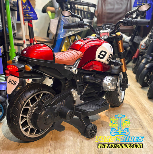 Child riding ToySNRIDES motorcycle with music system and LED headlights