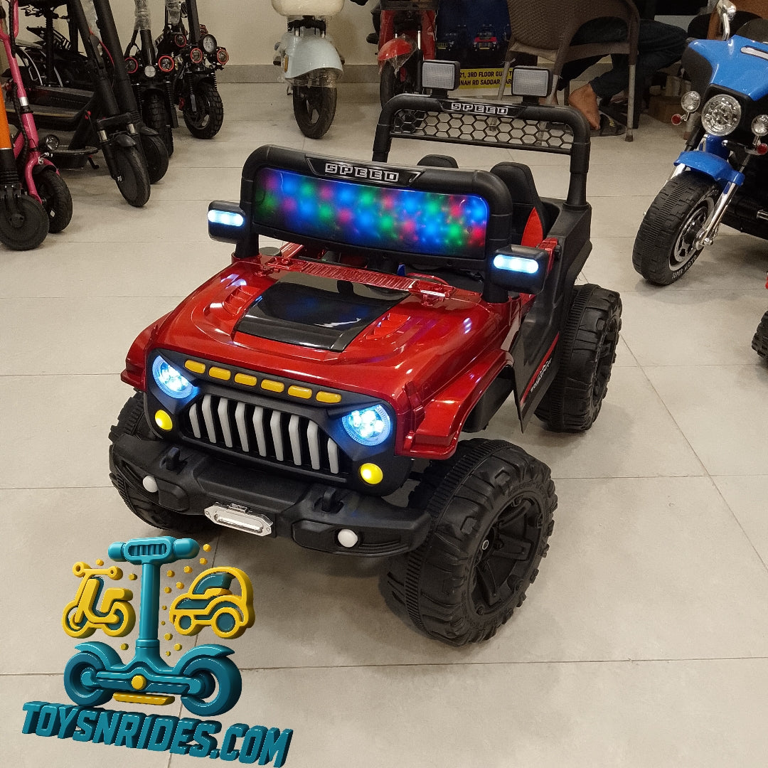 Red toy jeep with colorful lights in a showroom setting