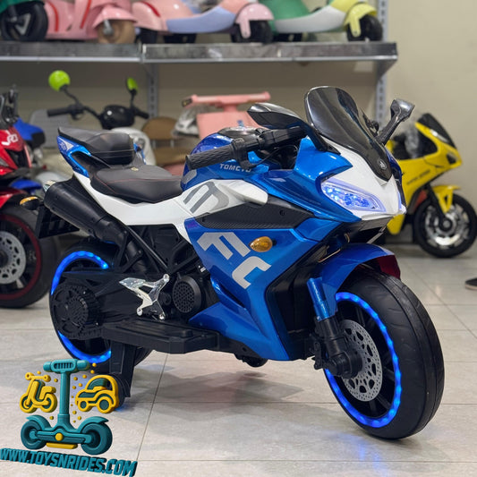 Blue toy motorcycle on a tiled floor, surrounded by other toys.