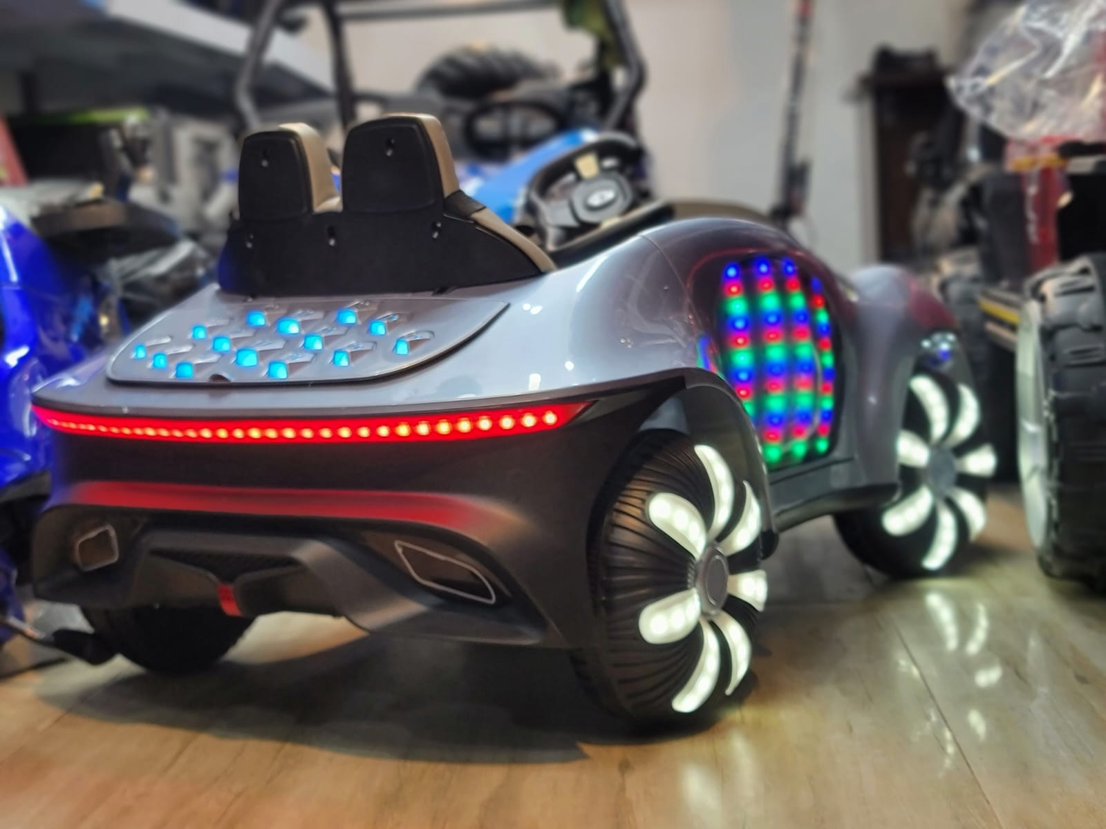 The back view of a stylish kids Mercedes car with light and music by TOYSNRIDES