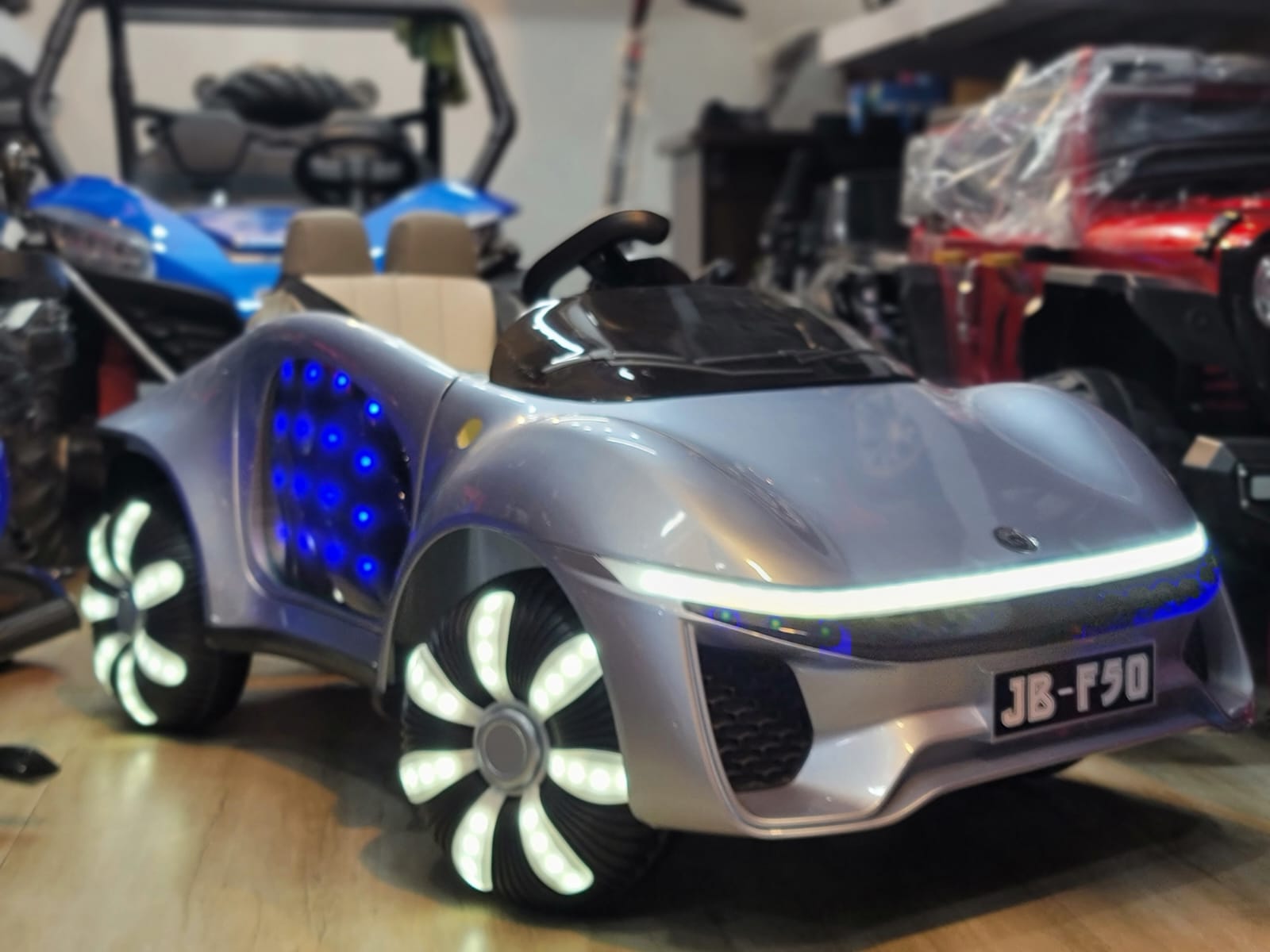 child playing with a TOYSNRIDES kids battery car featuring LED lights and music