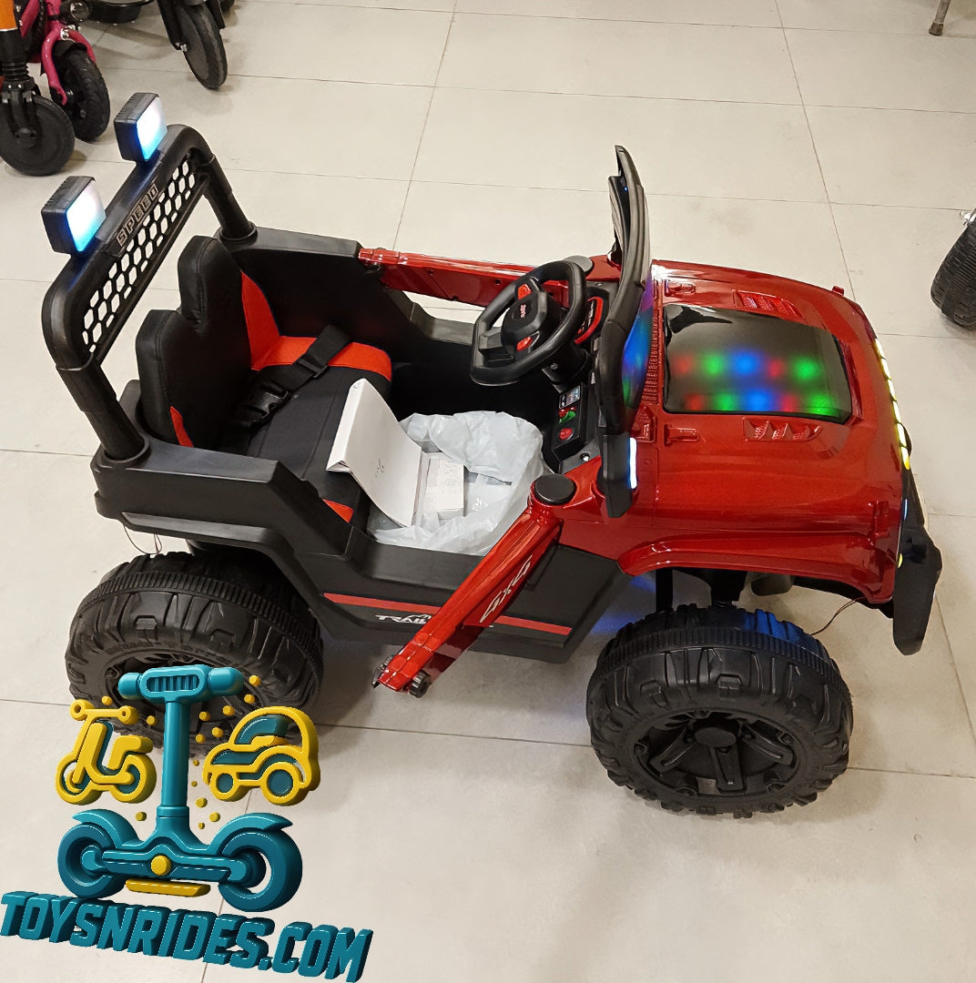 Red toy jeep with black accents on a tiled floor, featuring visible branding.