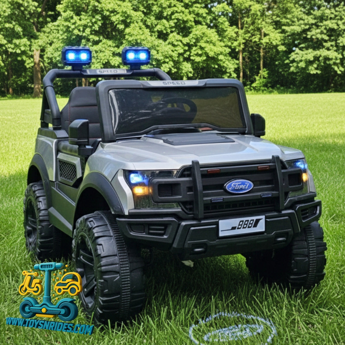 Toy Ford vehicle with lights on a grassy field, brand logo visible