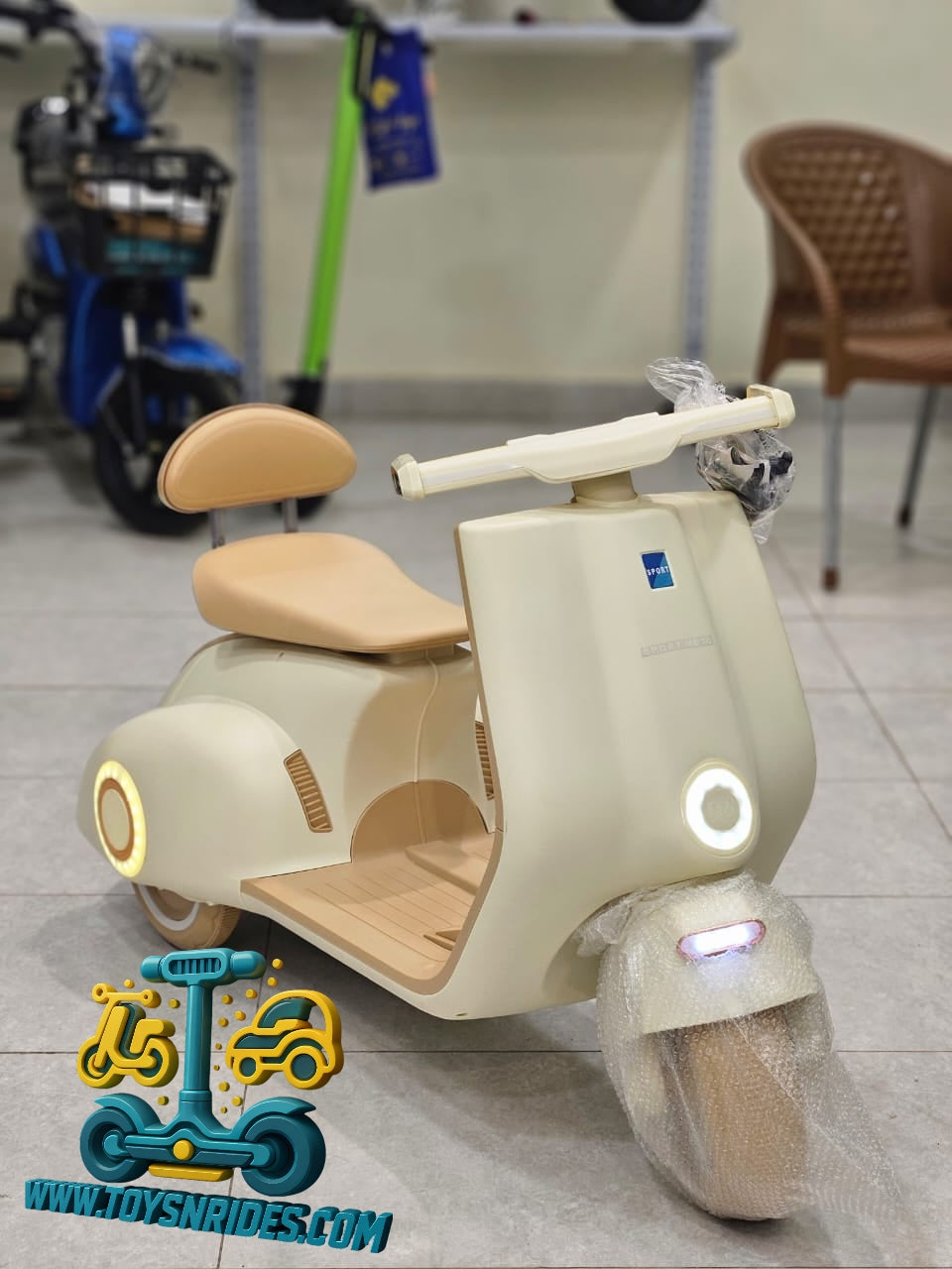 Children's toy scooter with beige and brown design on a tiled floor.