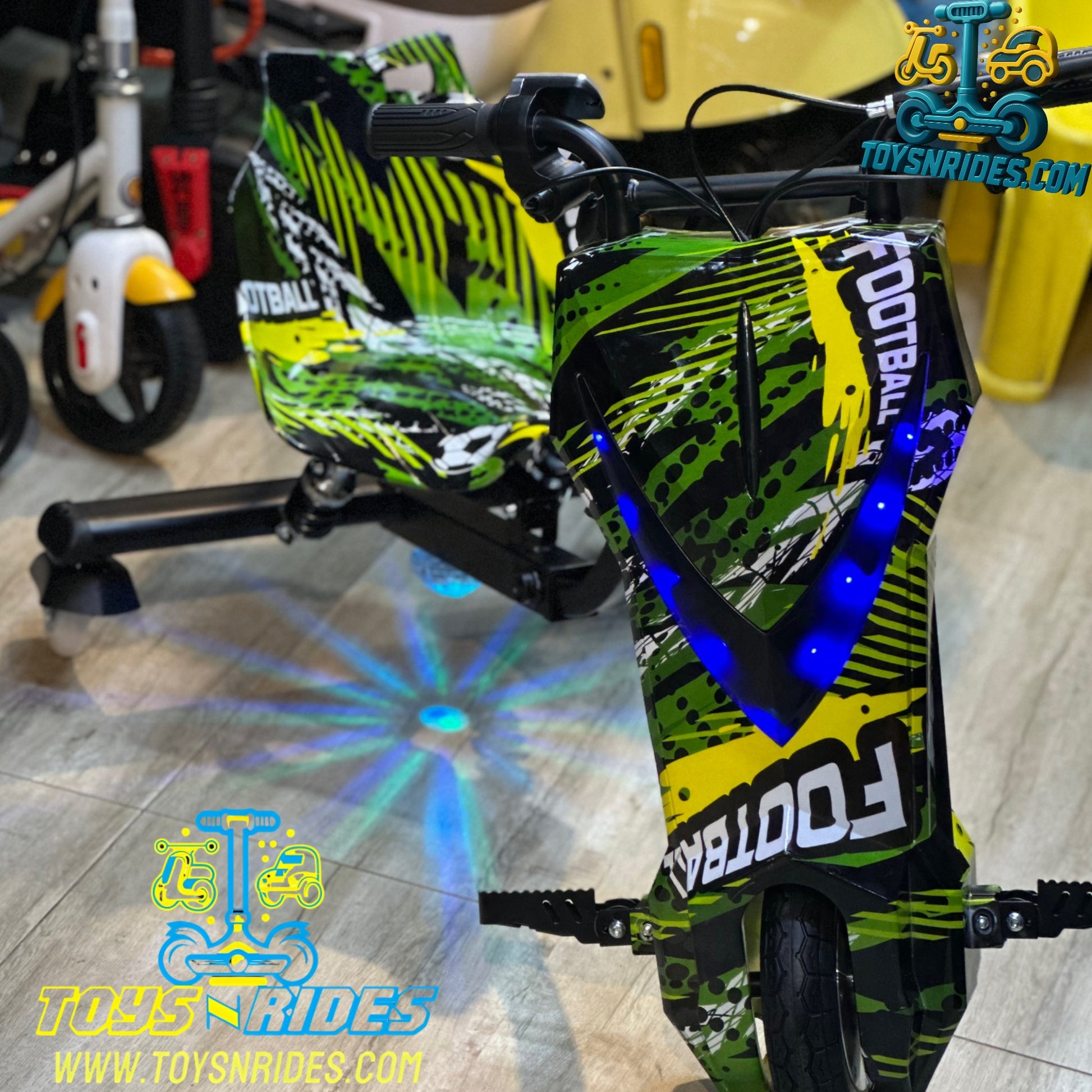 Children's drifting scooter with green and black design and blue LED lights on a tiled floor.