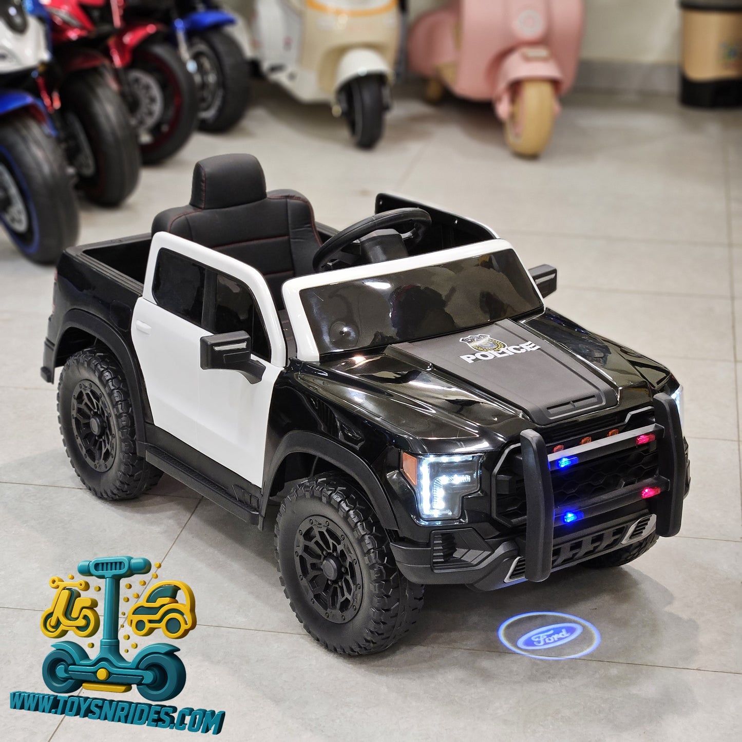 Children's toy police truck with lights on a tiled floor, brand 'Toys N Rides' visible.