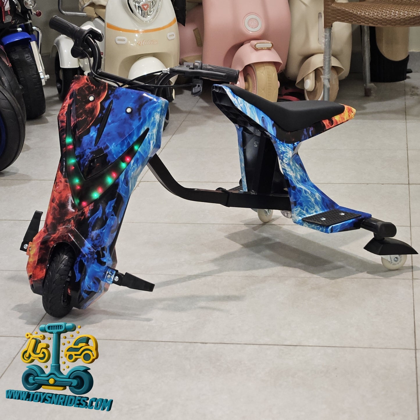 Colorful Drifting scooter with LED lights on a tiled floor, brand 'TOYSNRIDE.COM' visible.