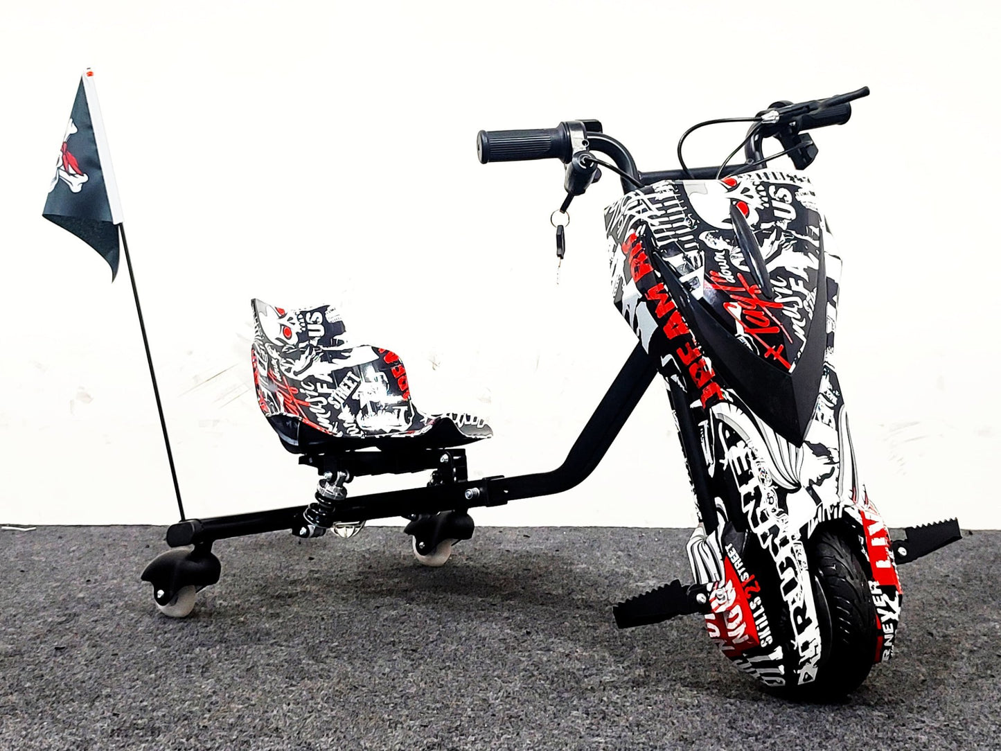 Children's trike with a helmet on a gray surface