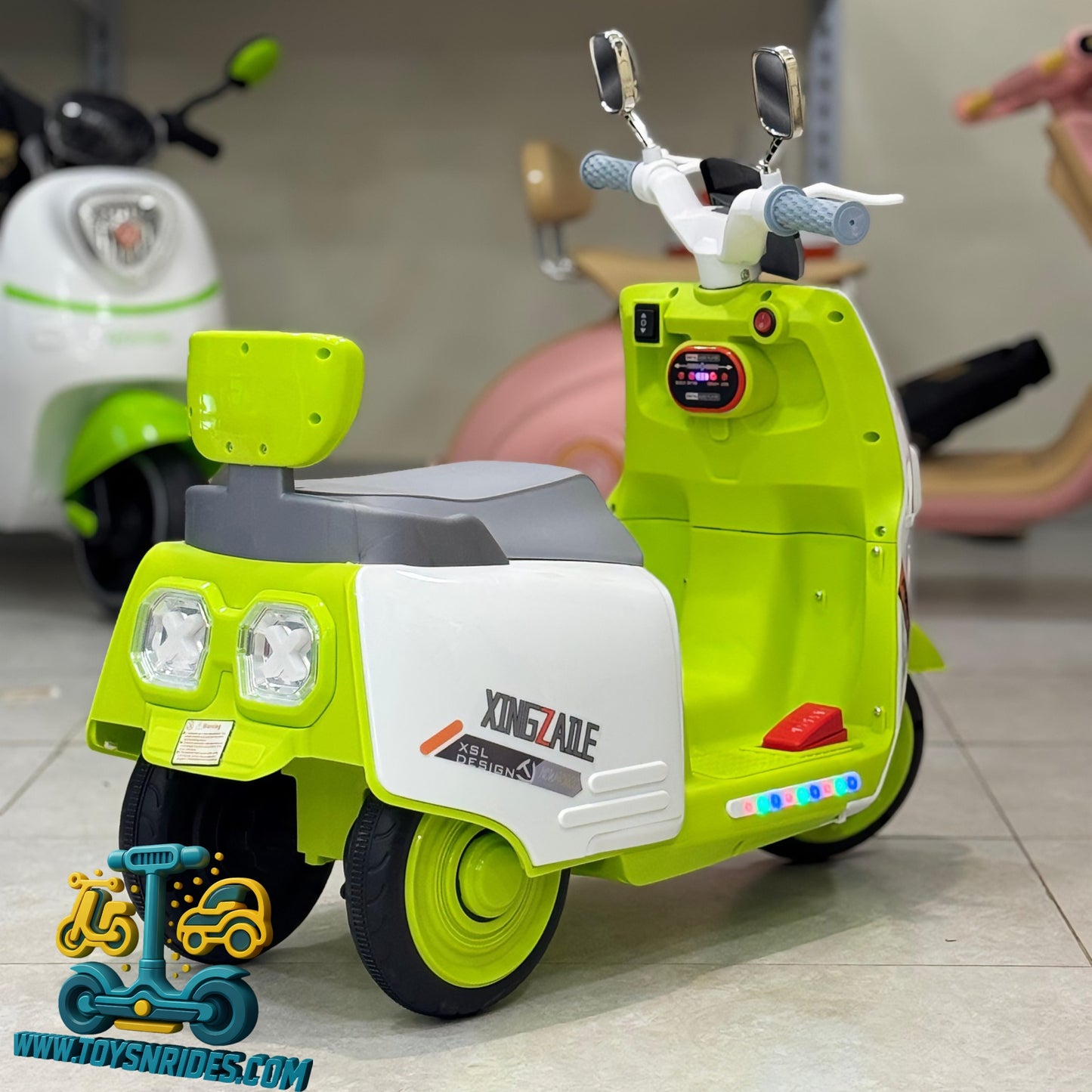Toy scooter with green and white colors on a tiled floor.