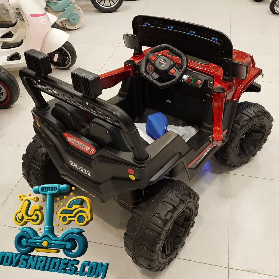 Children's toy car with black and red design on a tiled floor, brand 'ToysNrides.com' visible.