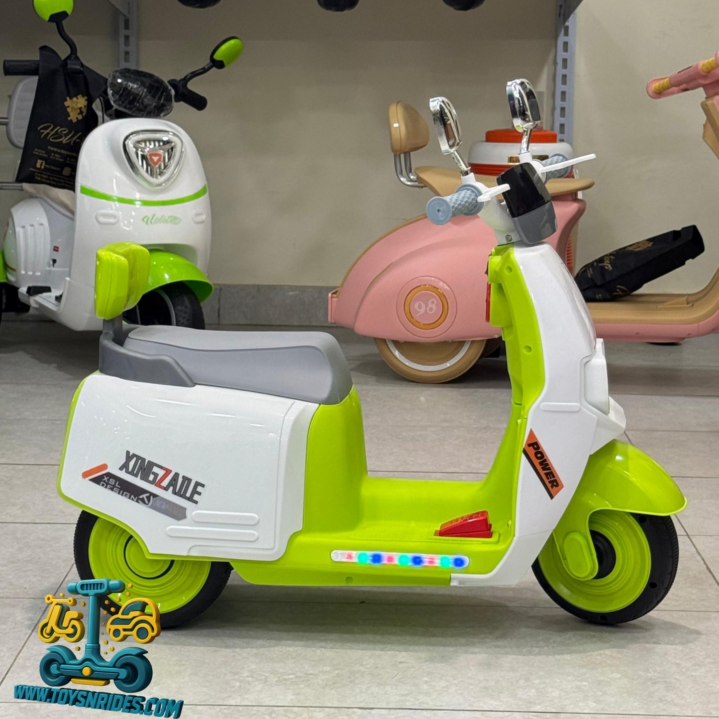 Children's toy scooter with green and white design in a store setting
