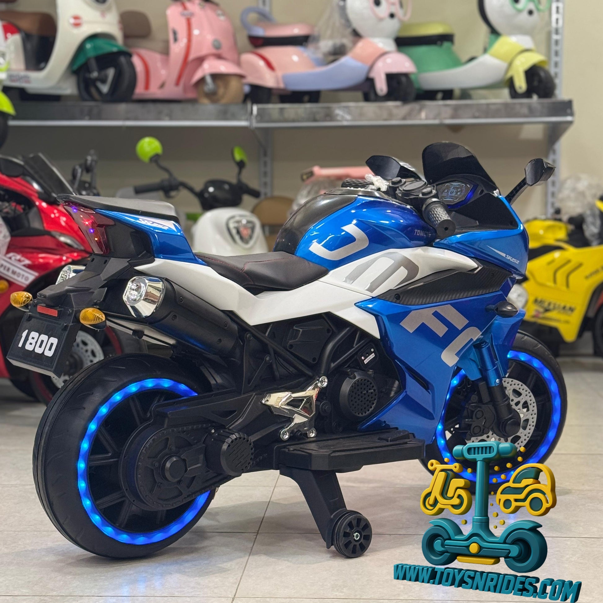 Blue and black toy motorcycle with LED wheels in a store setting