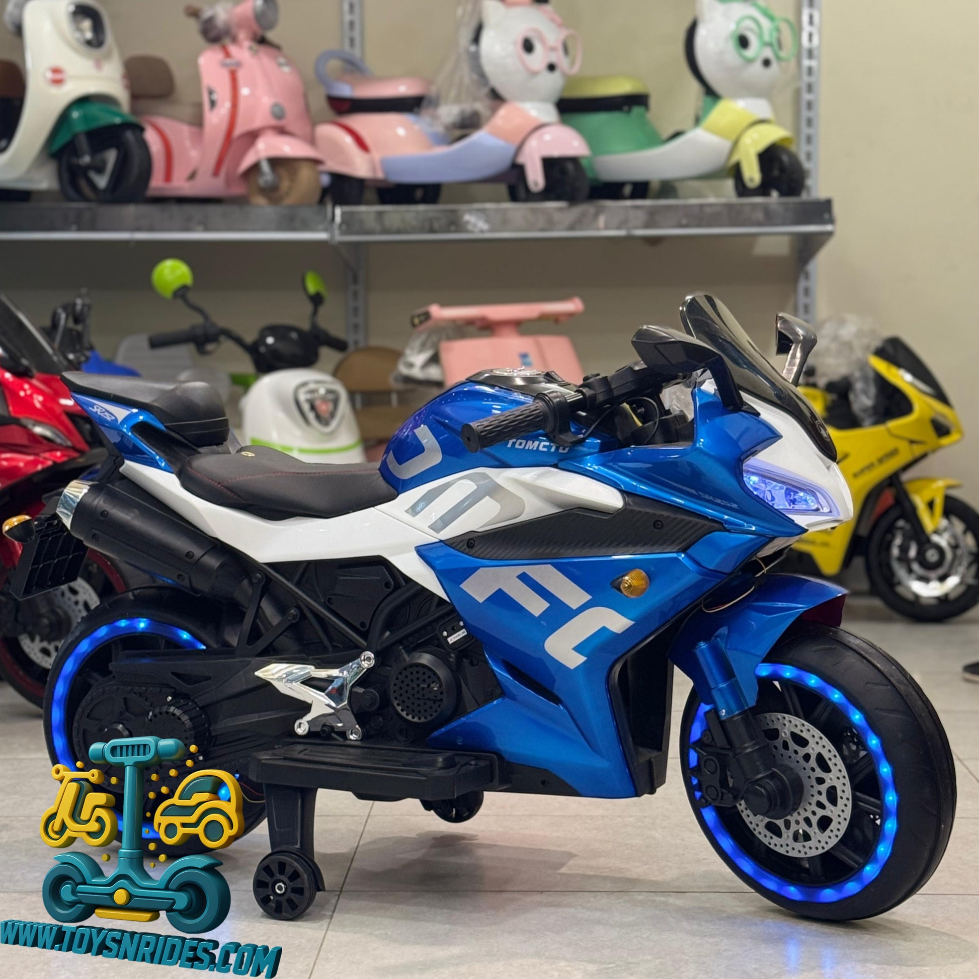 Blue toy motorcycle with white accents on a shelf with other toys in the background.