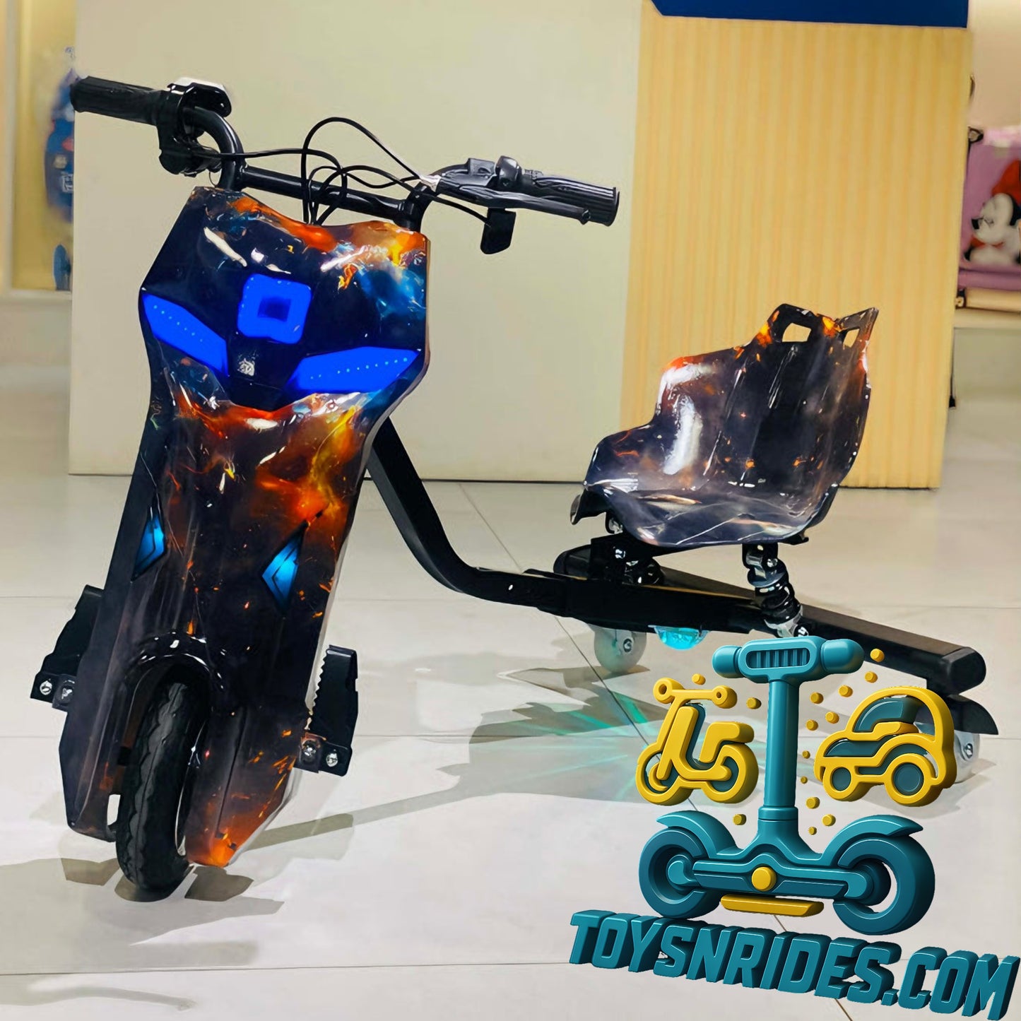 Children's toy scooter with flame-like design on a reflective surface, brand 'TOY SN RIDES' visible.