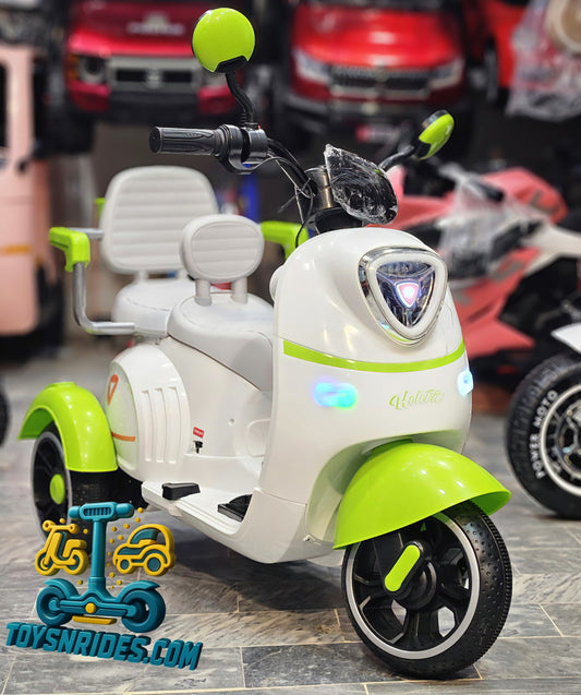Children's electric scooter with green accents in a store setting