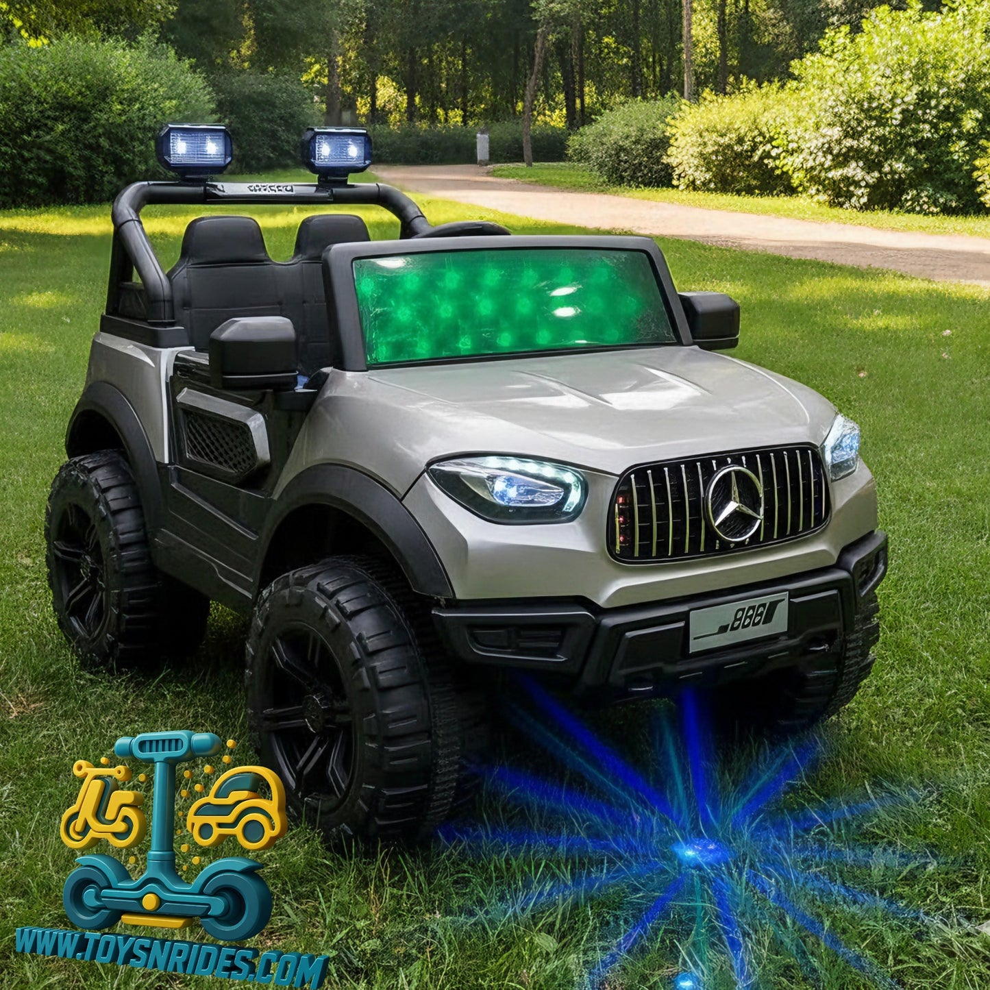 Children's toy car with Mercedes-Benz logo on a grassy area, featuring lights and a visible brand logo.