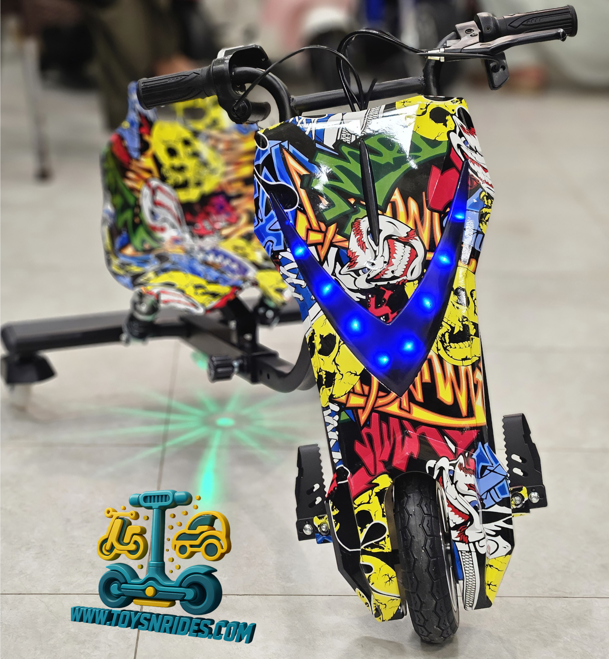 Colorful children's electric drift scooter with LED lights on a tiled floor.